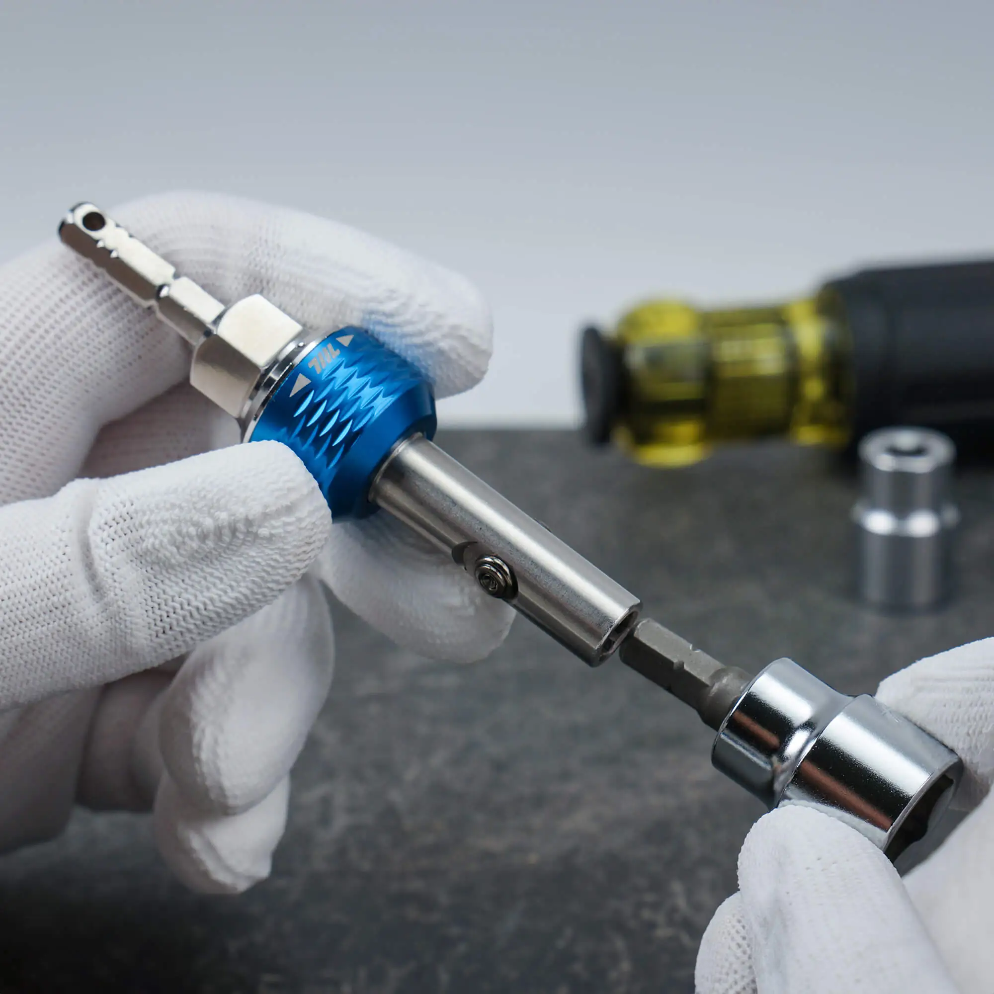 Inserting a bit into the magnetic holder of the 711L inline ratchet driver HEX on a grey background